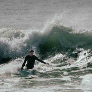 Dominik Mangliers surfs backside and grabs his rail in Caparica, Portugal